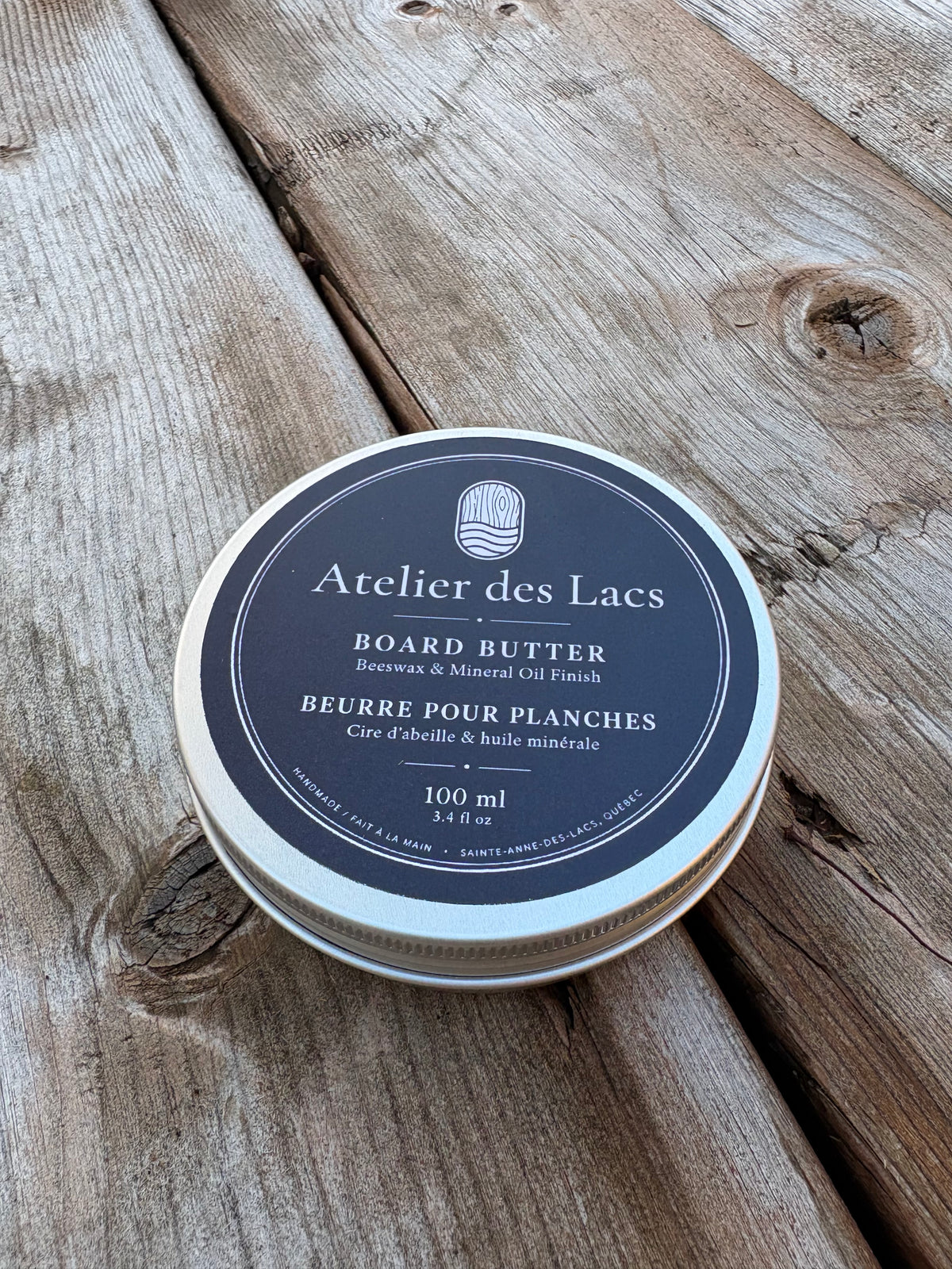 Atelier des Lacs board butter, 100 ml tin, on a wood deck