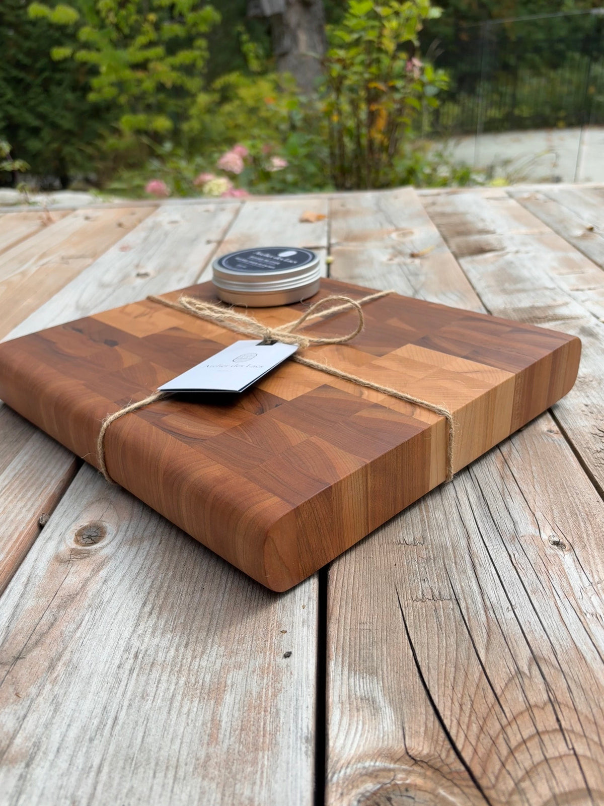 Cherry and maple end grain cutting board 11 x 12 in (sold), tied with twine, angled view