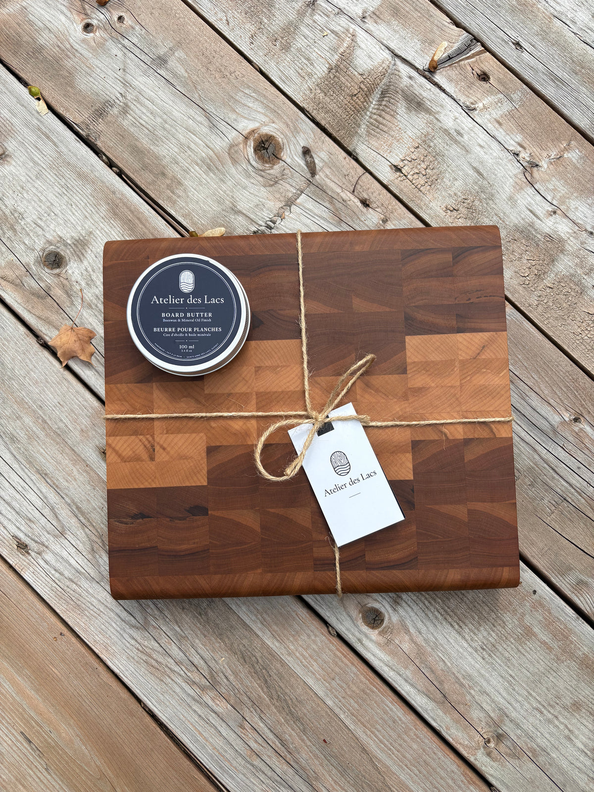 Cherry and maple end grain cutting board 11 x 12 in (sold), tied with twine, with board butter and a gift tag